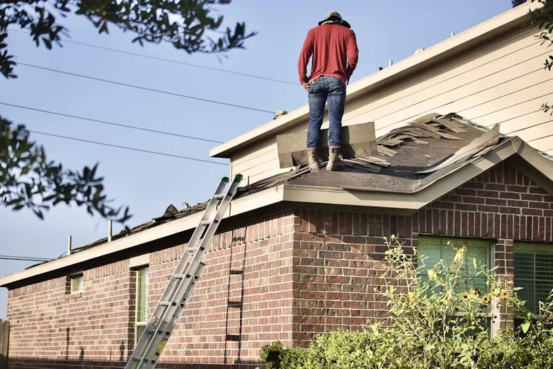 Professional roofer working on a residential roof in West Manheim